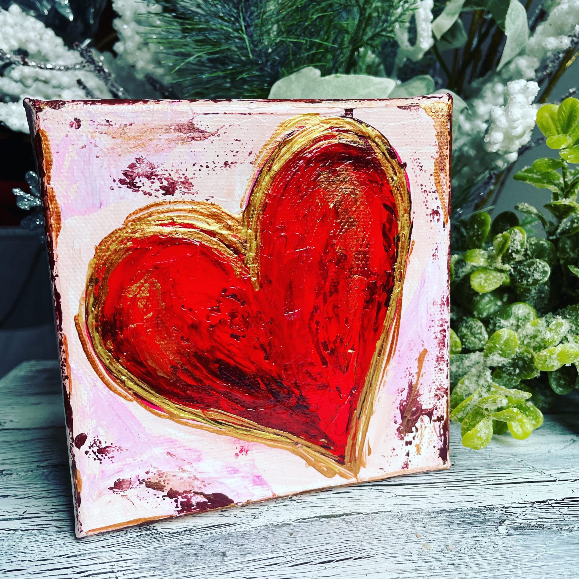 Red heart on pink canvas